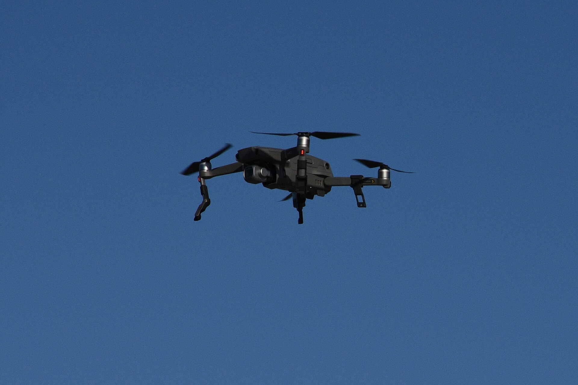 A DJI Mavic 2 Pro drone flying against a clear blue sky